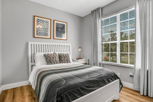 a bedroom with a large bed and a window at 3BD/3BA Windsor Hills, 10 min to Disney in Orlando