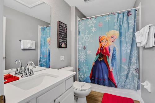 a bathroom with a sink and a shower curtain at 3BD/3BA Windsor Hills, 10 min to Disney in Orlando