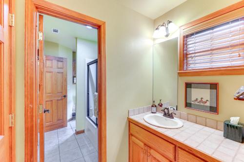 a bathroom with a sink and a mirror at Riverfront Cabin on 2 Acres in Glenwood! in Glenwood