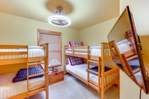 a bedroom with two bunk beds and a mirror at Riverfront Cabin on 2 Acres in Glenwood! in Glenwood
