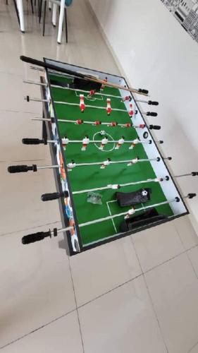 a large snooker table with people on it at Af Homes in Tangga Batu