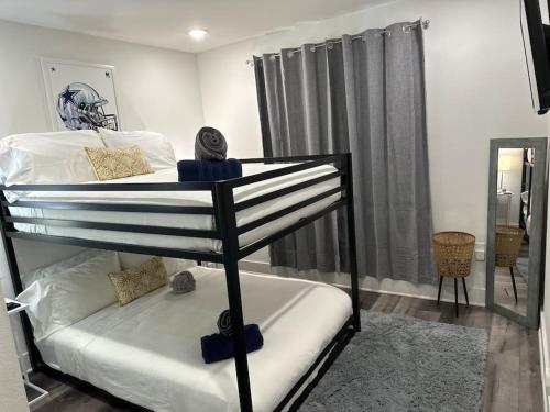 a bedroom with a bunk bed in a room at Cowboys Fan Pad 2 Bedroom! in Dallas
