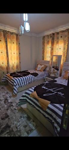 a room with three beds in a room at كمبوند الكناريا in Kafr Abū ʼumaydah
