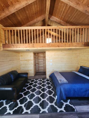 a bedroom with a bed and a loft at The Rocky Mountain Cabin in Apple Valley