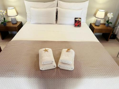 a hotel room with a bed with towels on it at PEDRO NAVARINO VII Laganas in Laganas