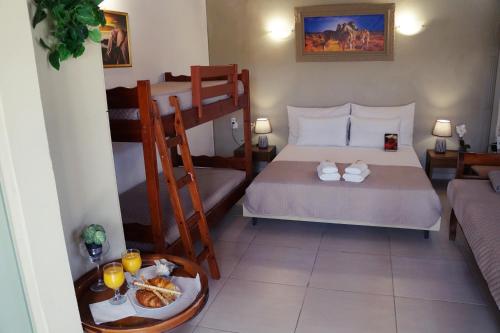 a bedroom with two bunk beds and a table with food at PEDRO NAVARINO VII Laganas in Laganas