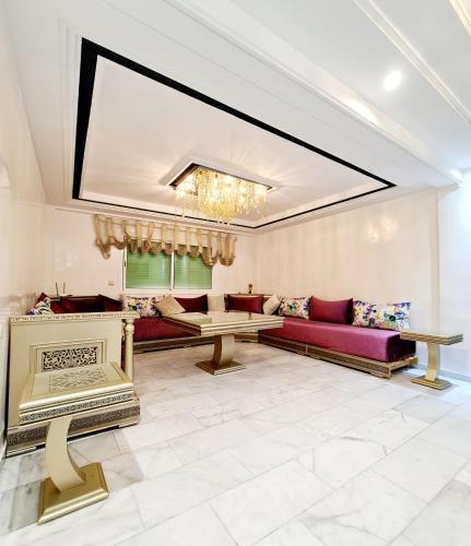 a living room with a couch and a table at Luxury Apartment Fes - Family Suites in Fès