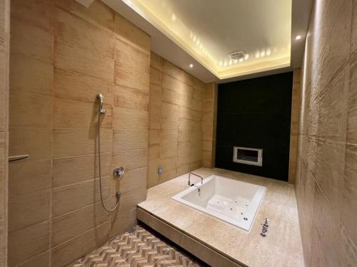 a bathroom with a bath tub and a shower at Aquarius Motel in Taichung