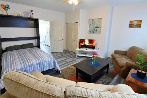 a living room with a bed and a couch at Cozy Sanctuary in Jersey City