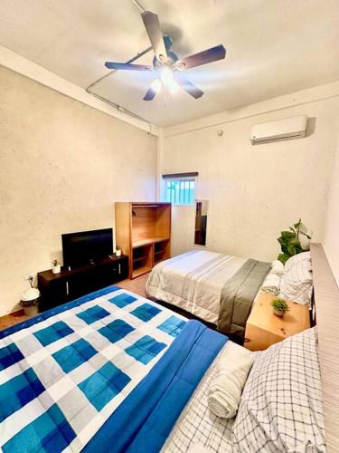 a bedroom with two beds and a ceiling fan at Departamento familiar equipado, 4 personas in Cabo San Lucas