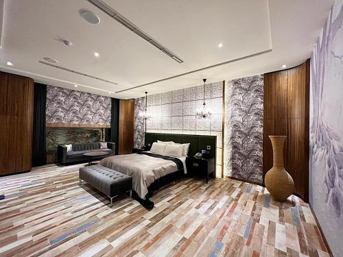 a bedroom with a bed and a table and a couch at Aquarius Motel in Taichung
