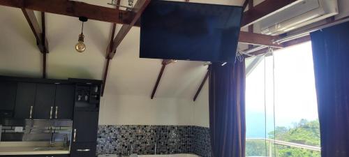 a kitchen with a large window and a large sink at Cabaña en el Aire con jacuzzi a 5min del Pueblo in Sopetran