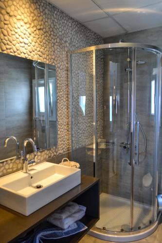 a bathroom with a sink and a shower at Alsalos villas in Amoopi