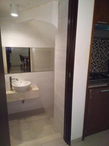 a bathroom with a sink and a mirror at Seminyak Apartment by LBV in Seminyak