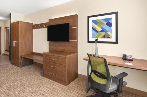 a room with a desk and a chair in a room at Holiday Inn Express Corning by IHG in Corning