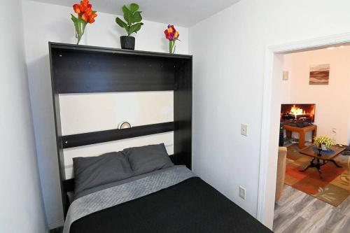 a bed with a black headboard in a room at Hidden Gem-1Bedroom with Plenty Free Street Parking in Communipaw