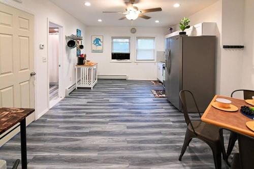 a kitchen with a refrigerator and a table and chairs at Hidden Gem-1Bedroom with Plenty Free Street Parking in Communipaw