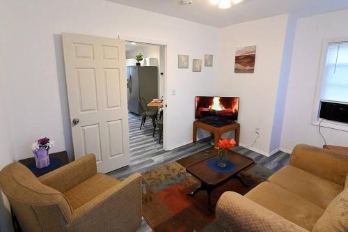 a living room with two chairs and a fireplace at Hidden Gem-1Bedroom with Plenty Free Street Parking in Communipaw