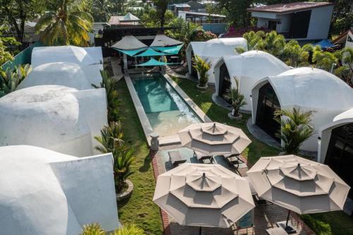 an aerial view of a resort with umbrellas and a pool at Alborada Boutique Stay in Uvita