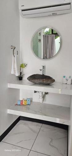 a bathroom with a sink and a mirror at Alborada Boutique Stay in Uvita
