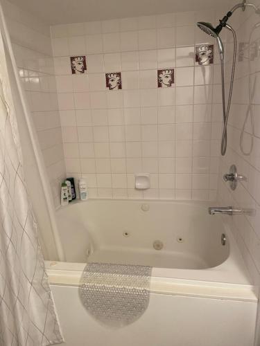 a bathroom with a bath tub with a shower at Modern Dream at Fairmont in Fairmont Hot Springs