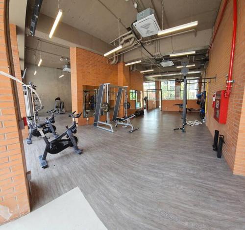a gym with several treadmills and machines in a room at Nuevo Depa con increible vista en YU Country 1804 in Guadalajara