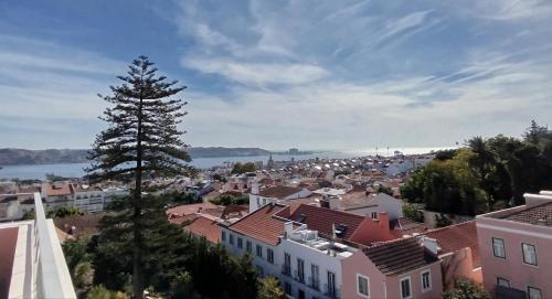 a view of a town with a tree at Ajuda Palace Inn Lisbon Apartments in Lisbon