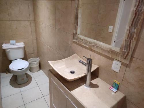 a bathroom with a sink and a toilet at Ashly Boulevard in Acapulco