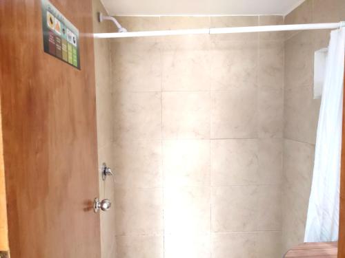 a bathroom with a shower with a shower curtain at Ashly Boulevard in Acapulco