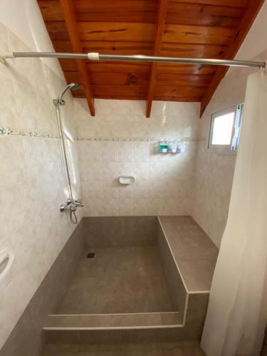 a bathroom with a shower and a bath tub at Cabañas flotter in Villa Ventana