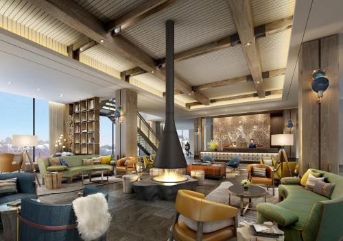 a lobby with couches and chairs and a fireplace at Holiday Inn Jilin Beidahu by IHG in Jilin