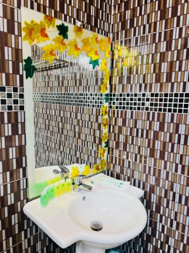 a bathroom with a sink and a mirror at K Garden Hotel Sungai Petani in Sungai Petani