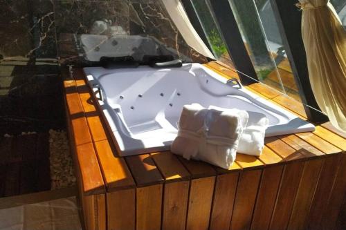 a bath tub sitting on top of a wooden deck at Refúgio dos Alpes cabana in Teresópolis