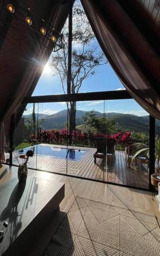 a view of a house with a view of a swimming pool at Refúgio dos Alpes cabana in Teresópolis