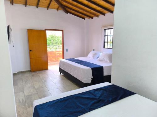 Ένα ή περισσότερα κρεβάτια σε δωμάτιο στο Hotel El Sol - Mesa de Los Santos