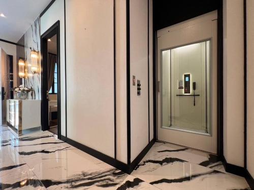 a hallway with two sliding doors in a building at Luxury Pool Villa 5BR 12pax with Private Lift in Ekkamai in Bangkok