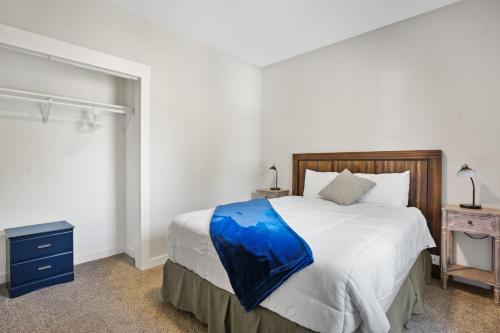 a bedroom with a bed with a blue blanket on it at Spacious 6BR less than 10 min walk to DT WI Dells! in Wisconsin Dells