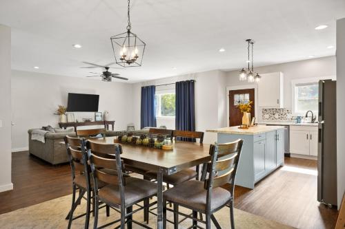 a kitchen and living room with a table and chairs at Spacious 6BR less than 10 min walk to DT WI Dells! in Wisconsin Dells
