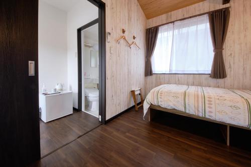 Postel nebo postele na pokoji v ubytování Cottage Kutsuroki