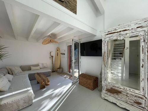 a white living room with a couch and a table at Villa rénovée avec accès plage, clim, WiFi, parking - FR-1-413-248 in Capbreton