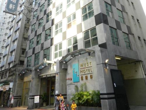 awest hotel building with people standing outside of it at West Hotel in Hong Kong