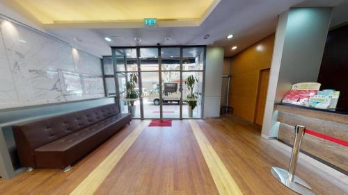 a lobby with a couch in the middle of a room at West Hotel in Hong Kong