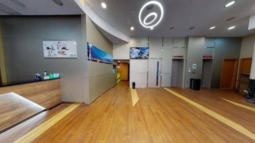 an empty room with a large room with wooden floors at West Hotel in Hong Kong