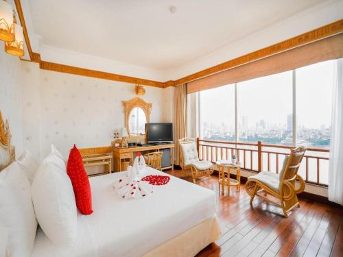 a hotel room with a bed and a balcony at Senriver Hotel in Danang