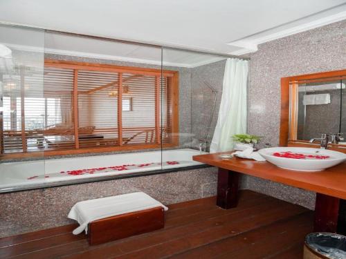 a bathroom with a large tub and a sink at Senriver Hotel in Danang