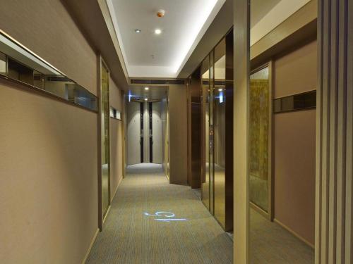 a corridor of a building with at Elysion Place Hotel Causeway Bay in Hong Kong