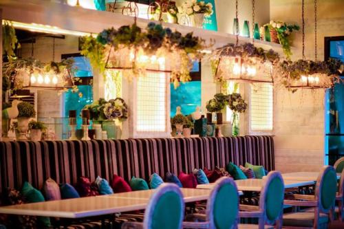 a row of tables with colorful pillows on them at Islands Hotel in Roxas City