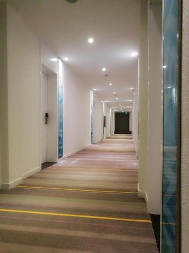 a hallway of a building with a long corridor at 7 Days Inn·Ulanqab Tsining railway station in Ulanqab