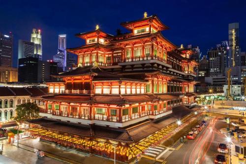 a chinese building with lights on it at night at Hotel Soloha @ Chinatown in Singapore