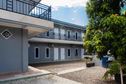 an external view of a building with a balcony at SPOT ON 2063 Bethania Residence in Kupang